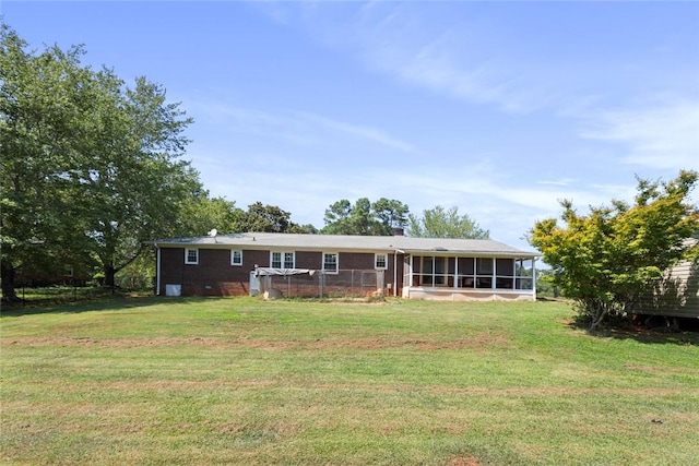 123 Radisson Rd, Seneca, SC 29678 - back of house featuring a sunroom, a lawn, brick siding, and a chimney
