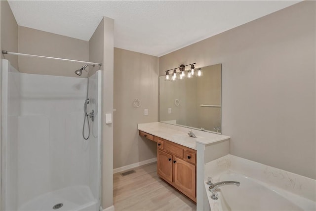 208 Playground Rd, Walhalla, SC 29691 - full bath featuring vanity, a walk in shower, a bath, and wood finished floors