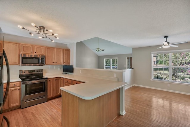 208 Playground Rd, Walhalla, SC 29691 - kitchen with stainless steel appliances, a peninsula, a ceiling fan, light countertops, and light wood finished floors