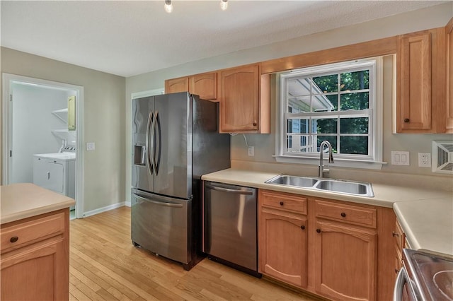 208 Playground Rd, Walhalla, SC 29691 - kitchen featuring stainless steel appliances, washing machine and dryer, light wood-style floors, and light countertops