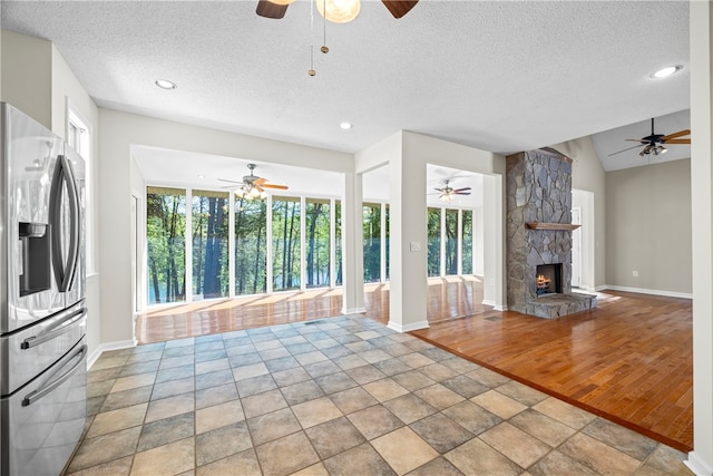 168 Wilderness Pt, Hartwell, GA 30643 - unfurnished living room with a ceiling fan, a fireplace, a textured ceiling, and recessed lighting