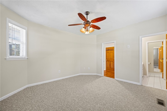 168 Wilderness Pt, Hartwell, GA 30643 - unfurnished bedroom with light carpet, ensuite bathroom, and a ceiling fan