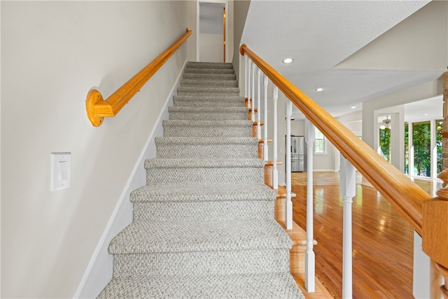 168 Wilderness Pt, Hartwell, GA 30643 - staircase featuring wood finished floors, recessed lighting, and a textured ceiling