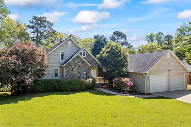 168 Wilderness Pt, Hartwell, GA 30643 - view of front of home featuring stone siding, a front lawn, concrete driveway, and an outbuilding