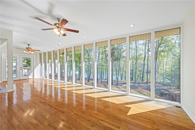 168 Wilderness Pt, Hartwell, GA 30643 - unfurnished living room with wood finished floors, ceiling fan, french doors, recessed lighting, and a wall of windows