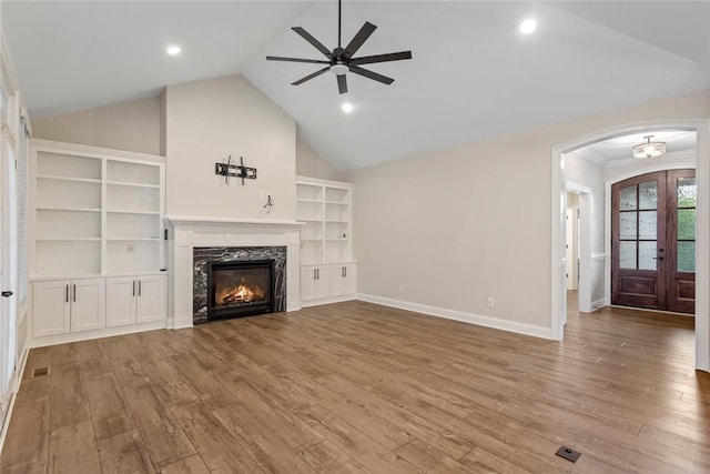 340 Fiddlers Way, Seneca, SC 29678 - unfurnished living room featuring ceiling fan, wood finished floors, a premium fireplace, arched walkways, and vaulted ceiling