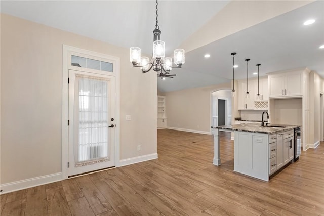 340 Fiddlers Way, Seneca, SC 29678 - kitchen featuring arched walkways, lofted ceiling, dark stone countertops, a chandelier, and white cabinetry