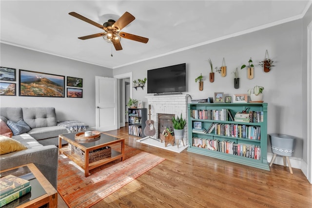 423 Lebanon Rd, Pendleton, SC 29670 - living area with a ceiling fan, ornamental molding, a brick fireplace, and wood finished floors