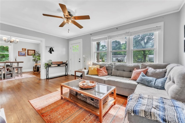 423 Lebanon Rd, Pendleton, SC 29670 - living room featuring plenty of natural light, wood finished floors, a chandelier, ornamental molding, and ceiling fan