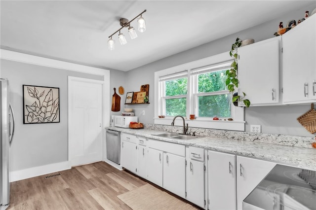 423 Lebanon Rd, Pendleton, SC 29670 - kitchen featuring appliances with stainless steel finishes, light wood-style flooring, and white cabinets