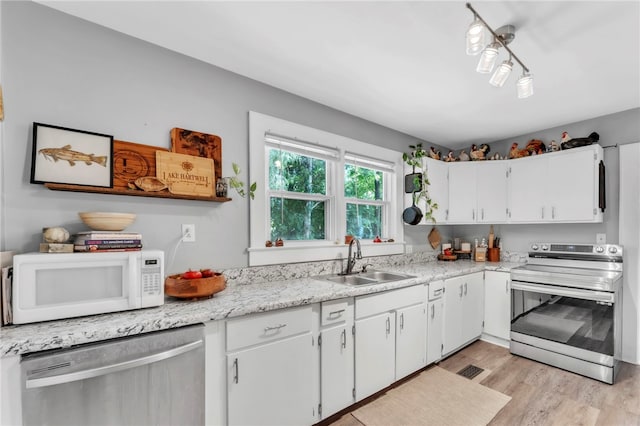 423 Lebanon Rd, Pendleton, SC 29670 - kitchen with appliances with stainless steel finishes, white cabinetry, light wood-type flooring, and light countertops