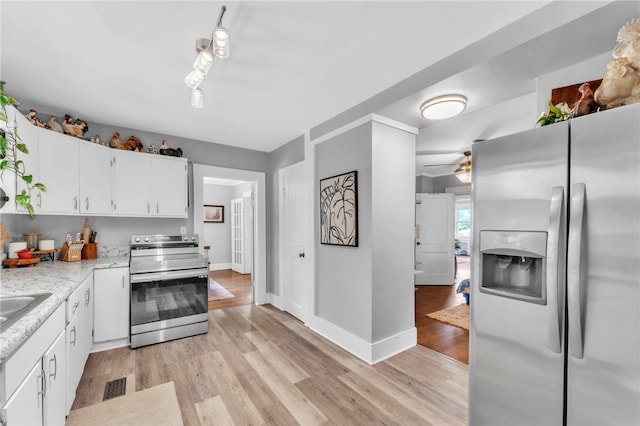 423 Lebanon Rd, Pendleton, SC 29670 - kitchen with appliances with stainless steel finishes, light wood finished floors, white cabinets, and ceiling fan
