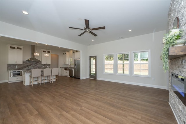 218 W Halfway Branch Rd, Walhalla, SC 29691 - unfurnished living room with a stone fireplace, a ceiling fan, dark wood-style floors, and recessed lighting