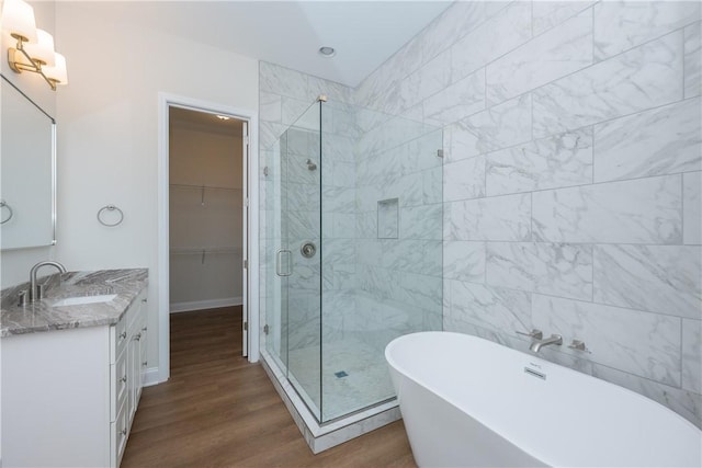 218 W Halfway Branch Rd, Walhalla, SC 29691 - bathroom featuring a stall shower, a freestanding tub, vanity, wood finished floors, and a walk in closet