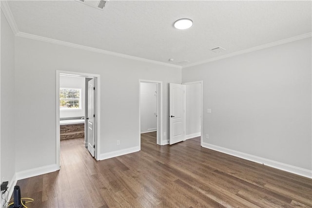 973 Pine Plain Rd, Gaston, SC 29053 - unfurnished bedroom featuring dark wood-type flooring, crown molding, and a walk in closet