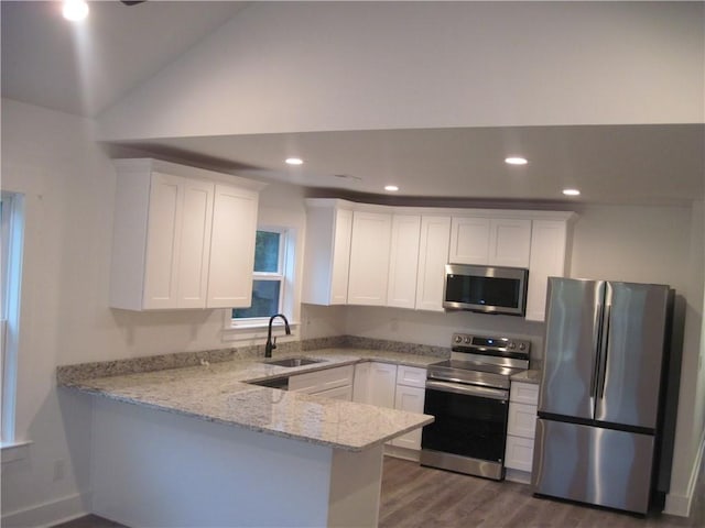 203 Ridgecrest Way, Williamston, SC 29697 - kitchen featuring appliances with stainless steel finishes, light stone countertops, a peninsula, white cabinets, and dark wood-style floors