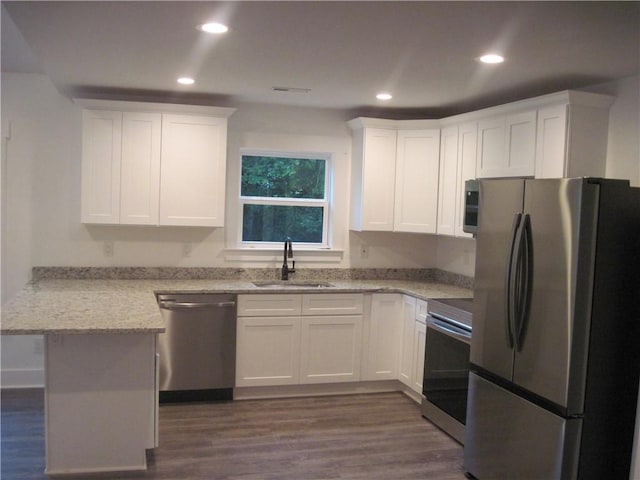 203 Ridgecrest Way, Williamston, SC 29697 - kitchen featuring stainless steel appliances, a peninsula, dark wood-type flooring, white cabinets, and recessed lighting