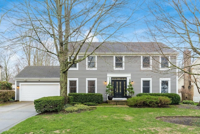 colonial-style house with a garage and a front lawn