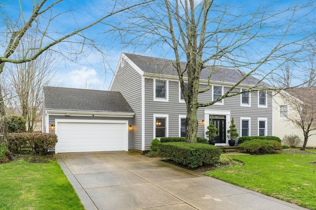 colonial-style house with a front yard and a garage