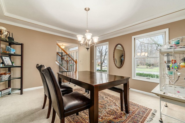 carpeted dining area featuring crown molding, a wealth of natural light, and an inviting chandelier