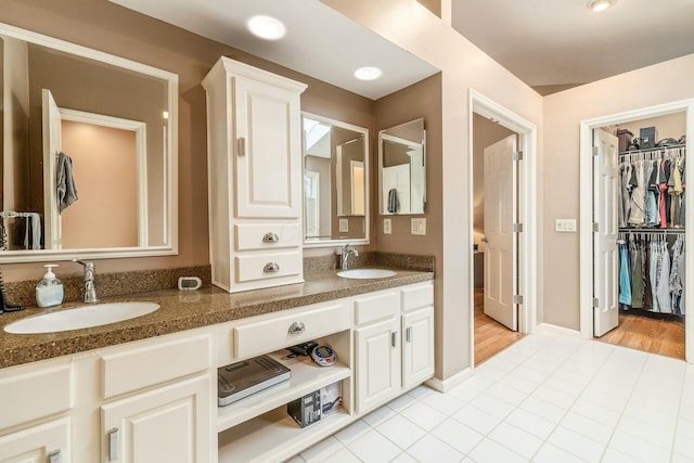 bathroom with tile patterned flooring and vanity