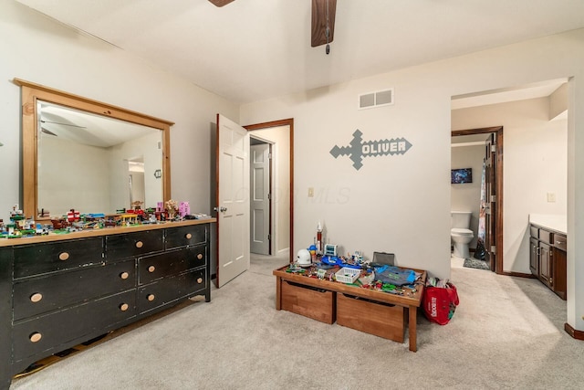 carpeted bedroom featuring ensuite bathroom and ceiling fan