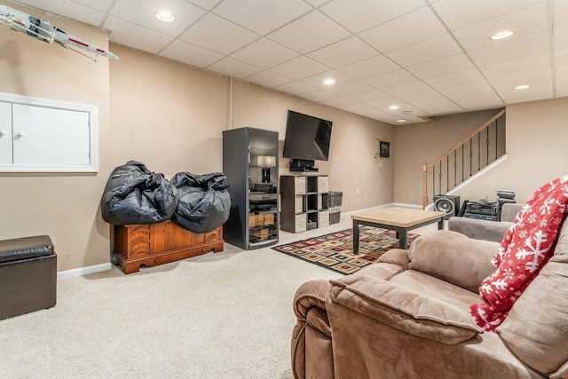 carpeted living room with a paneled ceiling