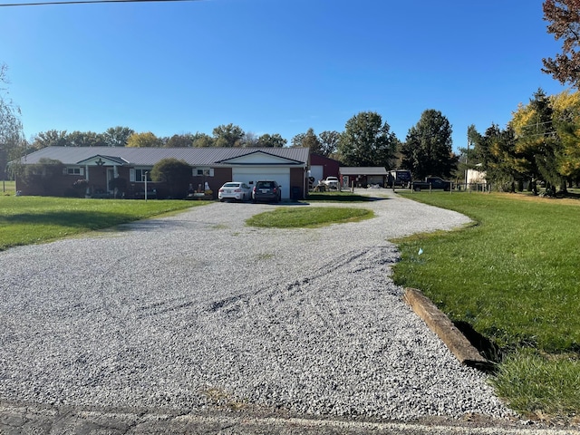 view of front of house with a garage and a front lawn