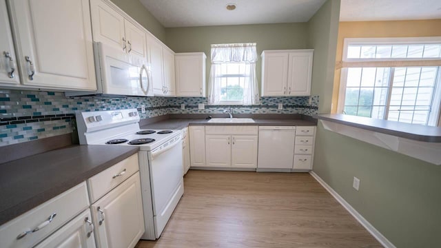 5901 Hickory Brook Way, Columbus, OH 43213 - kitchen with white appliances, plenty of natural light, white cabinets, and decorative backsplash