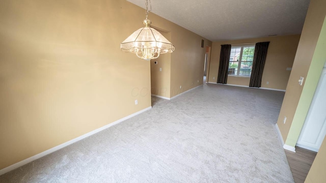 5901 Hickory Brook Way, Columbus, OH 43213 - spare room featuring a chandelier, a textured ceiling, and carpet flooring