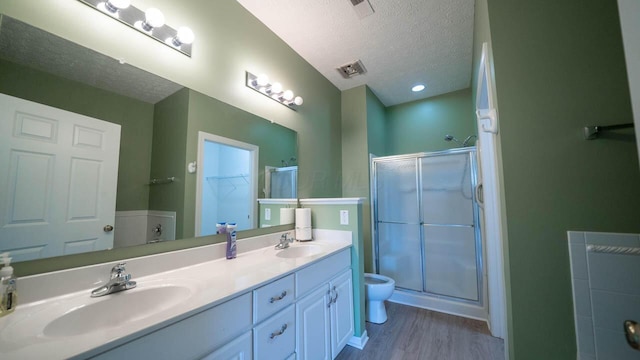 5901 Hickory Brook Way, Columbus, OH 43213 - bathroom with a textured ceiling, a stall shower, double vanity, wood finished floors, and a spacious closet