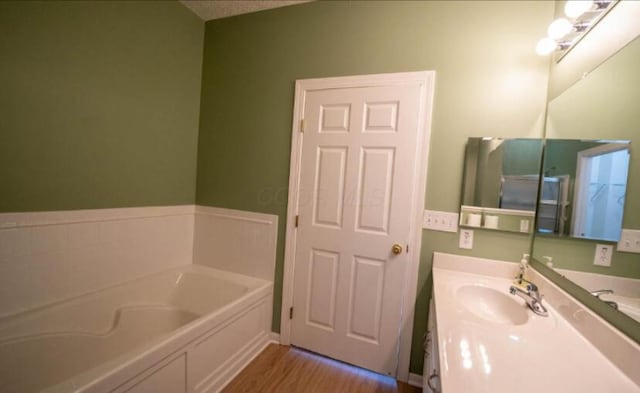 5901 Hickory Brook Way, Columbus, OH 43213 - bathroom with a bath, vanity, and wood finished floors