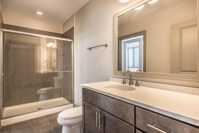 bathroom featuring vanity, toilet, and walk in shower