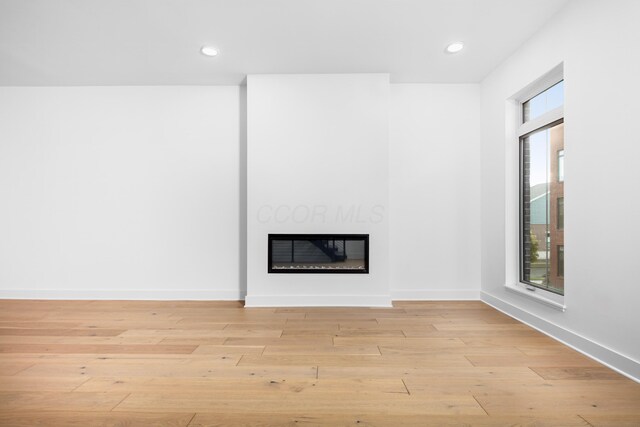 unfurnished living room featuring light wood-type flooring