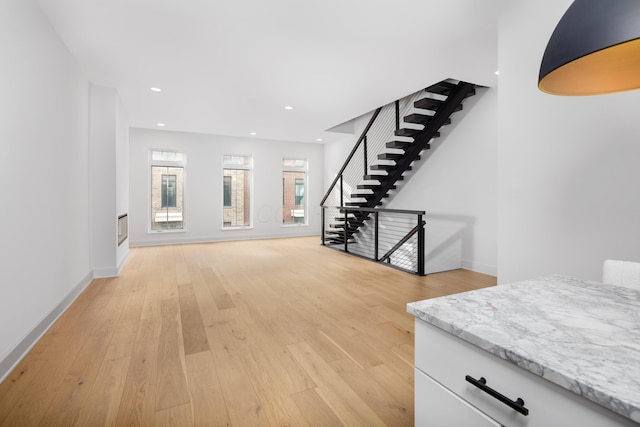 unfurnished living room featuring light wood-type flooring