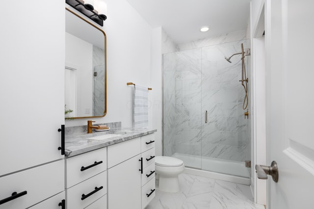 bathroom with toilet, vanity, and walk in shower