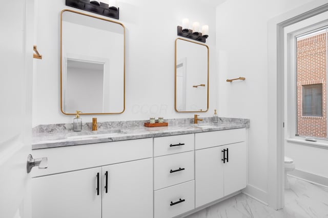 bathroom featuring toilet and vanity