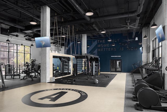 workout area with a towering ceiling