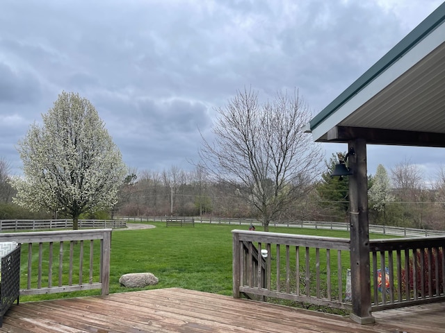 deck with a lawn and a rural view