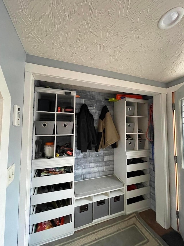 mudroom with a textured ceiling