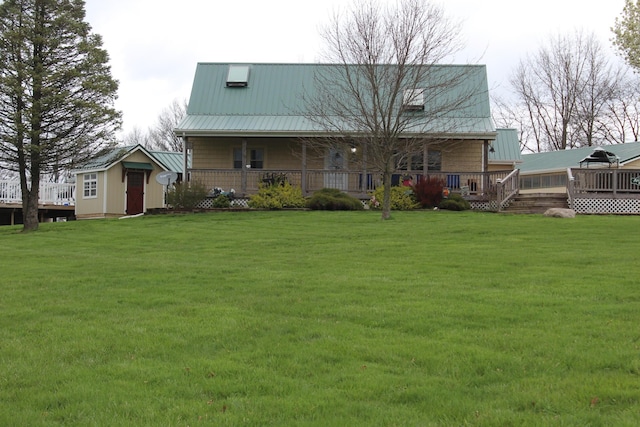 rear view of property with a storage shed and a yard