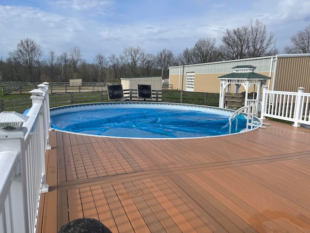 view of swimming pool featuring a gazebo and a wooden deck