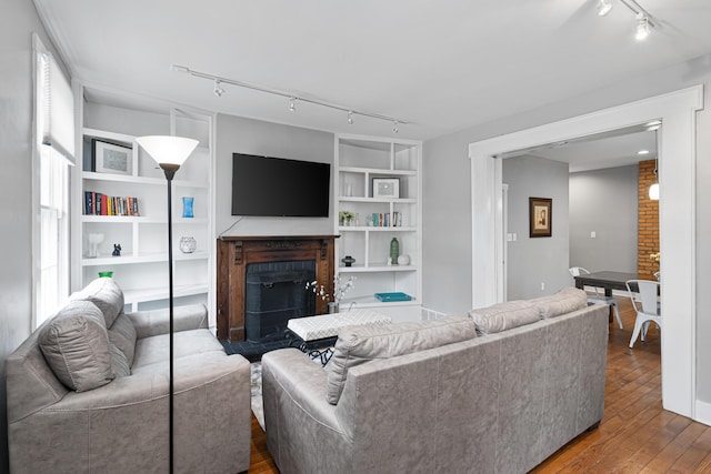 119 Redbud Aly, Columbus, OH 43206 - living area with track lighting, a brick fireplace, wood finished floors, and built in shelves