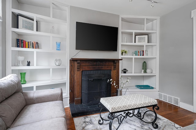 119 Redbud Aly, Columbus, OH 43206 - living area with a brick fireplace, dark wood-style flooring, and track lighting
