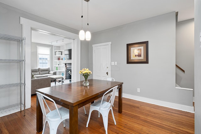 119 Redbud Aly, Columbus, OH 43206 - dining space featuring wood-type flooring, a fireplace, built in features, and stairway