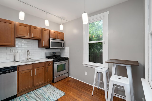 119 Redbud Aly, Columbus, OH 43206 - kitchen featuring stainless steel appliances, brown cabinets, backsplash, dark wood-type flooring, and light countertops
