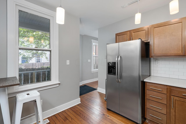 119 Redbud Aly, Columbus, OH 43206 - kitchen with stainless steel fridge, backsplash, hardwood / wood-style flooring, light countertops, and brown cabinetry