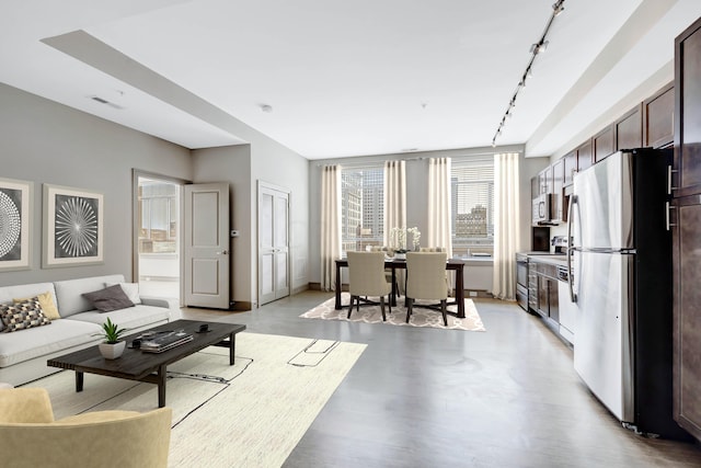 living room featuring rail lighting and light hardwood / wood-style floors