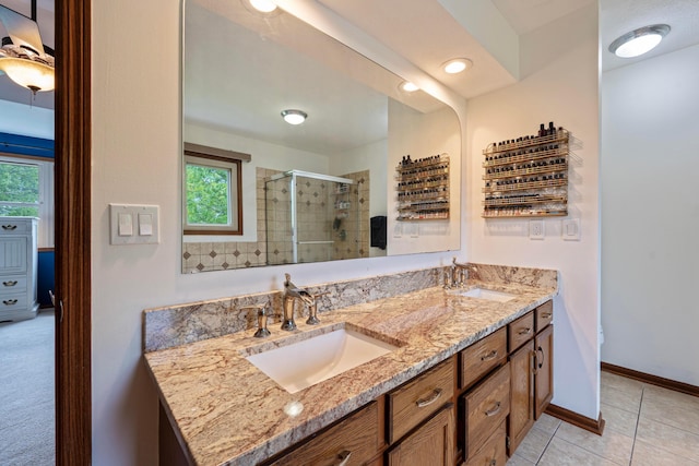 12627 Oakmere Dr, Pickerington, OH 43147 - full bathroom with a stall shower, double vanity, tile patterned floors, and baseboards