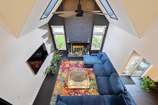 12627 Oakmere Dr, Pickerington, OH 43147 - living room featuring high vaulted ceiling, ceiling fan, plenty of natural light, a brick fireplace, and wood finished floors